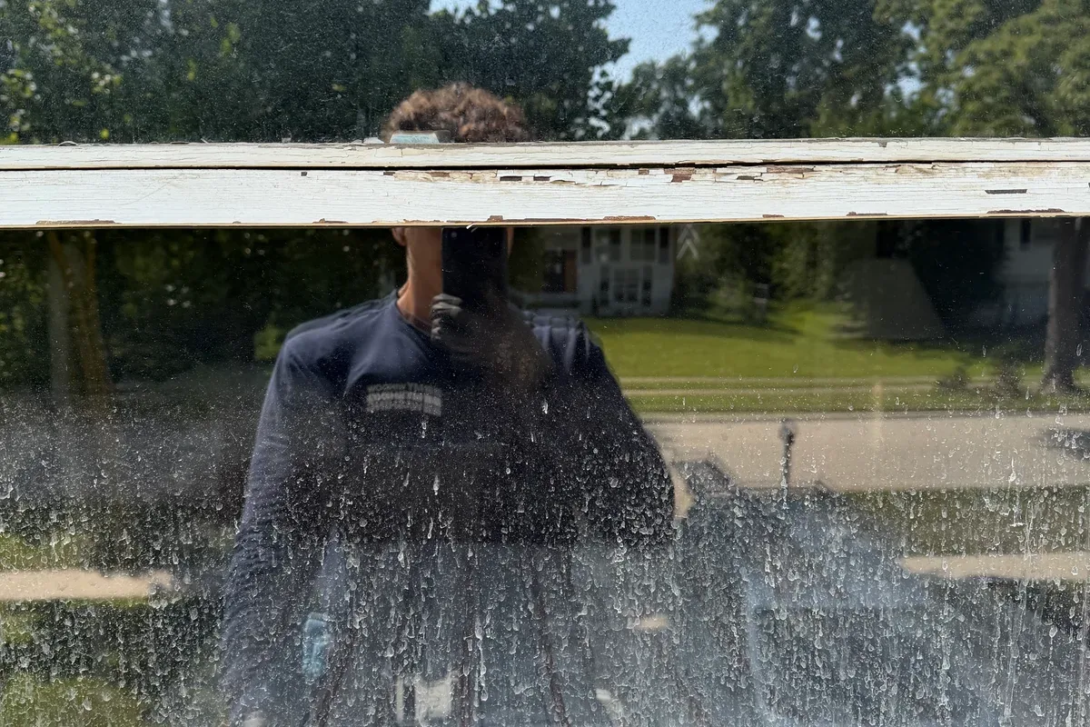 Window before washing, spotted glass on a two-story house in Lombard, IL